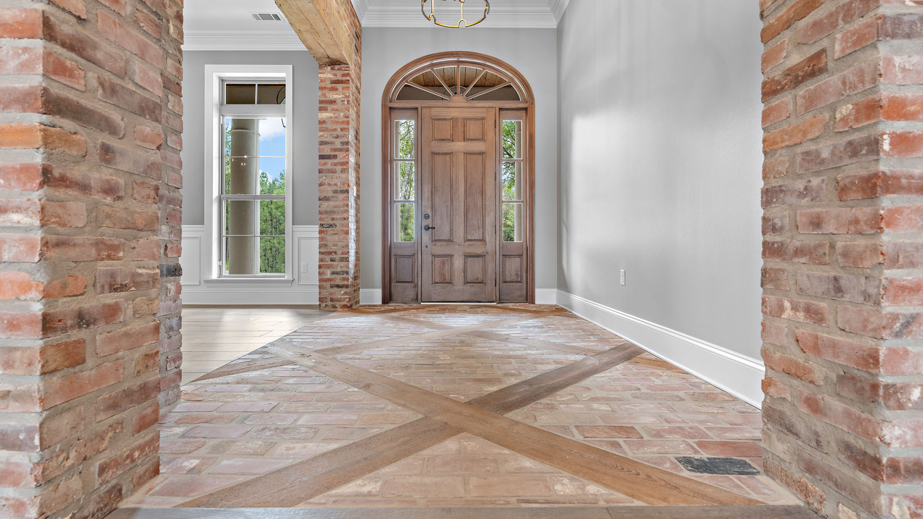 Entryway with gorgeous tile and custom woodwork in a custom home in Louisiana by Hurley Homes LLC